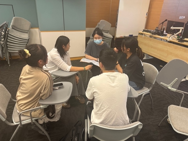 Students sharing reflections in a small group at the IIE seminar.